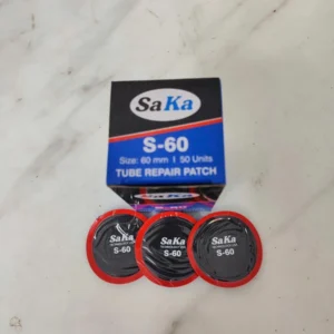Hộp miếng vá săm lốp SAKA-TECH S60 và 3 miếng vá viền đỏ đường kính 60mm trên bàn thợ